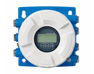 Endress+Hauser flow transmitter with circular white housing mounted on a blue panel and LCD display with control buttons